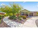 Beautiful home featuring mature landscaping and a winding walkway leading to a cozy front porch at 18129 N 65Th Pl, Phoenix, AZ 85054