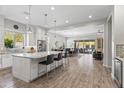 Spacious open-concept kitchen featuring a large island with seating, stainless steel appliances, and bright, airy design at 18129 N 65Th Pl, Phoenix, AZ 85054