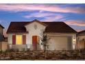 Charming single-story home boasting a red tile roof, cozy front porch, and meticulously landscaped yard at 20601 N 226Th Dr, Surprise, AZ 85387