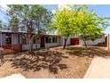 Private backyard featuring mature trees, a wooden fence and plenty of space for outdoor activities at 2122 W Piccadilly Rd, Phoenix, AZ 85015