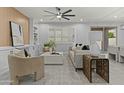 Cozy living room with a ceiling fan, modern furniture, and plantation shutters at 23046 E Camina Plata --, Queen Creek, AZ 85142