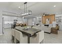 Open-concept space featuring a dining area, kitchen, and living room with contemporary design and decor at 23046 E Camina Plata --, Queen Creek, AZ 85142