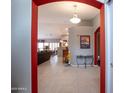 Open foyer leading to a spacious living area with tile flooring, decorative lighting, and neutral wall colors at 3022 N 148Th Ave, Goodyear, AZ 85395