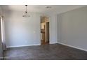 Spacious living room featuring tile flooring, neutral walls, and an arched doorway to an adjacent room at 3559 N 143Rd Ave, Goodyear, AZ 85395