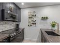 Updated kitchen features modern appliances, stylish backsplash, designer wine rack, and gold fixtures at 5995 N 78Th St # 2078, Scottsdale, AZ 85250
