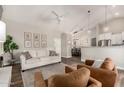 Spacious living room with hardwood floors, comfortable seating, and open layout at 6577 W Abraham Ln, Glendale, AZ 85308