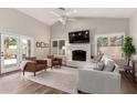 Bright living room features a brick fireplace, neutral color palette, and outdoor access at 6577 W Abraham Ln, Glendale, AZ 85308