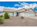 Well-maintained single-story home with three-car garage and drought-tolerant landscaping at 8516 W Saint John Rd, Peoria, AZ 85382