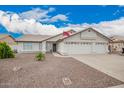 Beautiful single-story home with a three-car garage and low-maintenance desert landscaping at 8516 W Saint John Rd, Peoria, AZ 85382