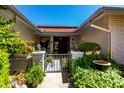 Charming entryway with decorative gate, brick pillars, and lush greenery creating a welcoming atmosphere to the home at 12954 W Blue Sky Dr, Sun City West, AZ 85375