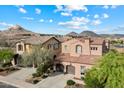 Charming two-story home featuring a tile roof, well-kept landscaping, and a two-car garage at 13648 W Jesse Red Dr, Peoria, AZ 85383