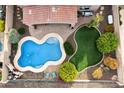 Aerial view of a private backyard with a pool, lush greenery, and patio area at 13648 W Jesse Red Dr, Peoria, AZ 85383