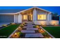 Well-lit front entrance with stone walkway, landscaped garden beds, and modern architectural design at 2178 E La Jolla Dr, Tempe, AZ 85282