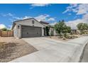 Well-maintained single-story home with desert landscaping and a spacious driveway at 21840 N 260Th Ln, Buckeye, AZ 85396