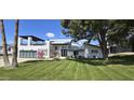 Beautiful modern house featuring a 3 car garage, a second story deck, and a manicured lawn at 2308 E State Ave, Phoenix, AZ 85020