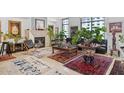 Bright living room featuring eclectic decor, fireplace, and lots of unique rugs and decorations at 2402 E Esplanade Ln # 604, Phoenix, AZ 85016