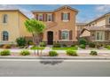 Charming two-story home featuring a well-manicured front yard, brown shutters, and a welcoming entrance at 4355 E Dennisport Ave, Gilbert, AZ 85295