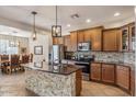 Updated kitchen with granite countertops, stainless steel appliances, and stone backsplash at 4554 S Cobblestone St, Gilbert, AZ 85297
