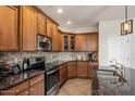 Beautiful kitchen featuring stone countertops, modern appliances, and tile flooring at 4554 S Cobblestone St, Gilbert, AZ 85297
