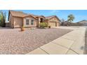 Street view of a charming single-story home featuring a well-maintained yard and a spacious two-car garage at 6102 W Shangri La Rd, Glendale, AZ 85304