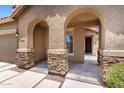 Stylish entryway featuring stone column accents and a neutral color palette creating an inviting entrance at 6557 S Classic Way, Gilbert, AZ 85298