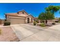 Inviting single-Gathering home boasts a tile roof, two-car garage, and well-kept landscaping, creating great curb appeal at 6557 S Classic Way, Gilbert, AZ 85298