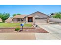 Charming home with neatly kept lawn, brick accents, and a well-maintained driveway leading to a two-car garage at 1210 W Stottler Dr, Chandler, AZ 85224