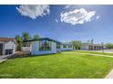 Charming single-story home with lush green lawn, walkway, and freshly painted exterior for great curb appeal at 1263 W Devonshire St, Mesa, AZ 85201