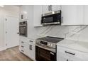 Updated kitchen featuring stainless steel oven, microwave, and white marbled countertops at 1313 N 71St St, Scottsdale, AZ 85257