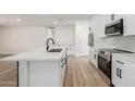 Bright kitchen showcasing white cabinets, quartz countertops, and stainless steel appliances at 1313 N 71St St, Scottsdale, AZ 85257