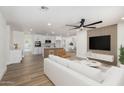 Open concept living area with a large white sofa, modern ceiling fan, and a view of the kitchen at 1313 N 71St St, Scottsdale, AZ 85257