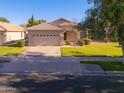 Attractive single-story home with a well-manicured lawn and a two-car garage at 1463 W Mead Dr, Chandler, AZ 85248