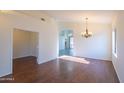 Spacious living room featuring wood-look floors, adjacent rooms, and natural light at 1463 W Mead Dr, Chandler, AZ 85248
