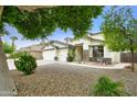 Charming curb appeal with desert landscaping, a seating area, and a well-maintained lawn, offering a warm welcome at 14823 W Windsor Ave, Goodyear, AZ 85395