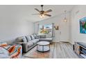 Inviting living room with vaulted ceiling, stylish gray sectional sofa, and bright window views at 16258 N 138Th Ave, Surprise, AZ 85374