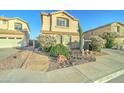 Inviting home with desert landscaping, colorful blooming bushes, and a walkway leading to the front door at 17009 S Coleman St, Phoenix, AZ 85045
