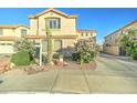 Beautiful home featuring desert landscaping with flowering bushes, cactus, and a well-manicured lawn at 17009 S Coleman St, Phoenix, AZ 85045