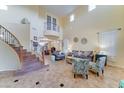 Spacious living room with high ceilings, a staircase, and large windows, perfect for entertaining guests at 17009 S Coleman St, Phoenix, AZ 85045