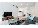 Bright living room featuring modern furnishings, stylish décor, and an open layout leading to the kitchen at 1701 E Colter St # 151, Phoenix, AZ 85016
