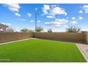 Green, newly installed back yard with block wall providing a private outdoor space at 20181 W Desert Bloom St, Buckeye, AZ 85326
