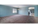Spacious living room with carpeted floors and natural light at 25386 W Darrel Dr, Buckeye, AZ 85326