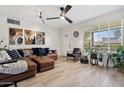 Bright living room featuring modern decor, hardwood floors, and a comfortable leather sectional sofa at 2908 E Pinchot Ave, Phoenix, AZ 85016