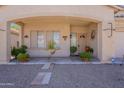 Cozy front porch adorned with potted plants, offering a welcoming entrance to this charming home at 2911 W Keim Dr, Phoenix, AZ 85017