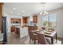 Eat-in kitchen with a large island, stainless steel appliances, and ample cabinet space at 2930 E Quiet Hollow Ln, Phoenix, AZ 85024