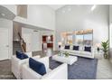 Bright, airy living room with high ceilings, neutral colors, and large windows at 2930 E Quiet Hollow Ln, Phoenix, AZ 85024