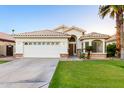 Well-maintained single-Gathering home with a clean driveway, a two-car garage and desert landscaping at 3152 N 83Rd Pl, Scottsdale, AZ 85251