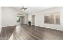Spacious living room with wood-look flooring, a fireplace, sliding glass doors, and plenty of natural light at 3152 N 83Rd Pl, Scottsdale, AZ 85251