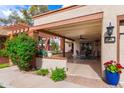 Inviting front porch with brick columns, terracotta accents, and a spacious outdoor seating area at 34 Leisure World --, Mesa, AZ 85206