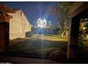 Exterior of a home at night featuring a community globe, greenery, and architectural details at 34 Leisure World --, Mesa, AZ 85206