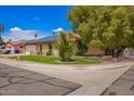 Well-maintained home featuring a green lawn and energy-efficient solar panels on the roof at 3556 E Angela Dr, Phoenix, AZ 85032